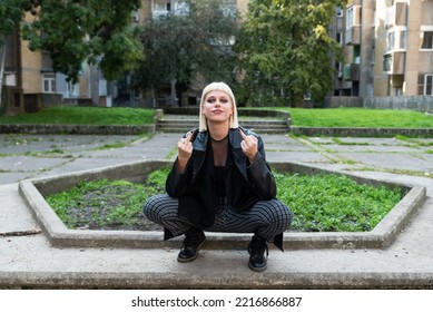 Young Beautiful Strong Independent Rebel Blonde Woman Punk Music And Style Fan Posing. Confident Punk-Rock Youth Culture Street Style Concept.