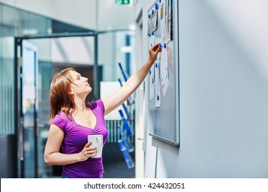 Young Beautiful Student At College Or University Using Notice Board