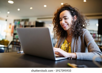 Young Beautiful Student Girl Working, Learning In College Library