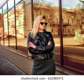 Young Beautiful Stylish Blonde Woman In A Leather Jacket On A City Street.