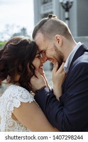 Young beautiful stylish pair of newlyweds hugs each other and stay face to face with smile on stairs. - Shutterstock ID 1407298244