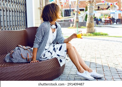 Young Beautiful Stylish Woman, Sitting On The Street Bench, Traveling Alone, Enjoy Her Free Time, Wearing Vintage Hipster Trendy Outfit, Drinking Smoothie, Enjoy Weekends.