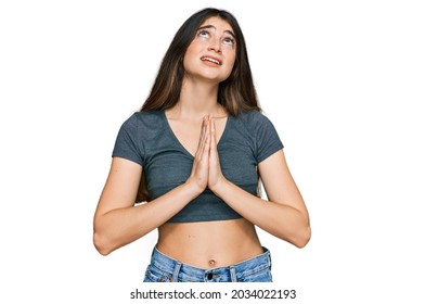 Young Beautiful Teen Girl Wearing Casual Crop Top T Shirt Begging And Praying With Hands Together With Hope Expression On Face Very Emotional And Worried. Begging. 