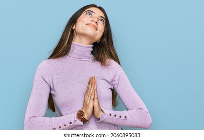 Young Beautiful Teen Girl Wearing Turtleneck Sweater Begging And Praying With Hands Together With Hope Expression On Face Very Emotional And Worried. Begging. 