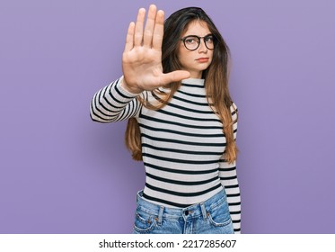 Young Beautiful Teen Girl Wearing Casual Clothes And Glasses Doing Stop Sing With Palm Of The Hand. Warning Expression With Negative And Serious Gesture On The Face. 