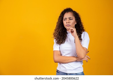 Young Beautiful Teen Student Girl Dreaming Thinking Looking In Side Over Yellow Background.