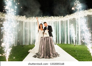 Young Beautiful Wedding Couple Cuts The Wedding Cake And Have Fun