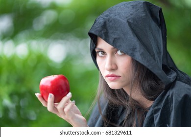 A Young Beautiful Witch With Red Apple