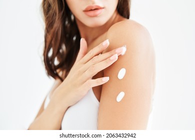 Young beautiful woman applying moisturizing cream on her body. skin, spa, body care concept