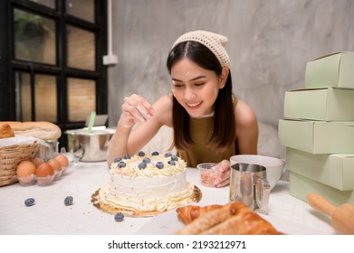 A Young beautiful woman is baking in her kitchen , bakery and coffee shop business - Powered by Shutterstock