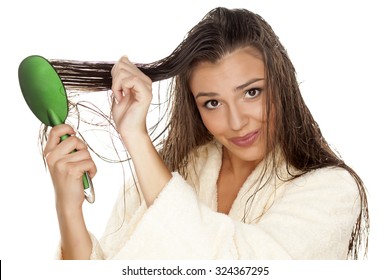 Young Beautiful Woman In Bathrobe Brush Her Moist Hair