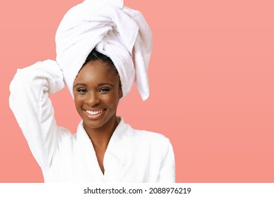 Young beautiful woman in bathrobe with white towel on head posing on pink background - Powered by Shutterstock