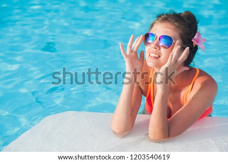 young beautiful woman in bikini relaxing in spa pool