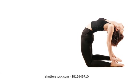young beautiful woman in black leggings and top doing indoor fitness on a white background