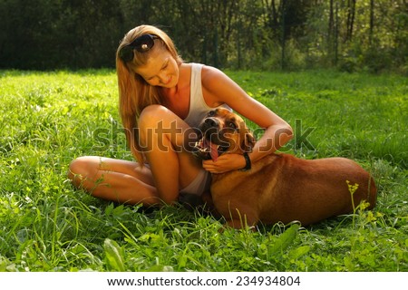 Similar – Pretty blond woman with her two dogs