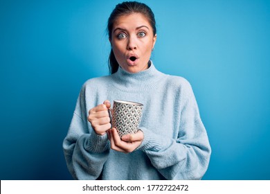 Young beautiful woman with blue eyes drinking mug of coffee over isolated background scared in shock with a surprise face, afraid and excited with fear expression - Powered by Shutterstock