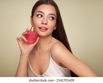 Young Beautiful Woman With A Bottle Of Perfume. Model With Healthy Skin, Close Up Portrait. Cosmetology, Beauty And Spa