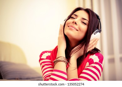 Young beautiful woman in bright outfit enjoying the music at home - Shutterstock ID 135052274