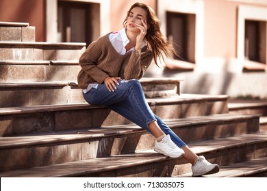Young and beautiful woman in casual clothes in the street. Autumn fashion concept.