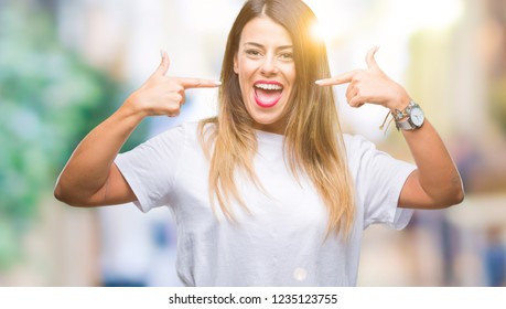 Young Beautiful Woman Casual White T-shirt Over Isolated Background Smiling Confident Showing And Pointing With Fingers Teeth And Mouth. Health Concept.