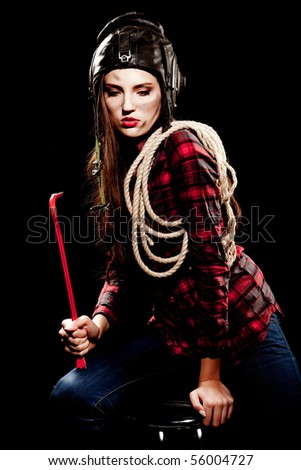young beautiful woman in cell shirt with red crowbar