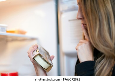 Young Beautiful Woman Checking Food From The Fridge