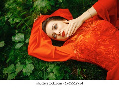young, beautiful woman with clear, sparkling skin on her face and body is lying in a tropical forest. Natural organic skin care. The concept of harmony with nature. - Shutterstock ID 1765519754