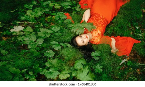 young, beautiful woman with clear, sparkling skin on her face and body is lying in a tropical forest. Natural organic skin care. The concept of harmony with nature. - Shutterstock ID 1768401836