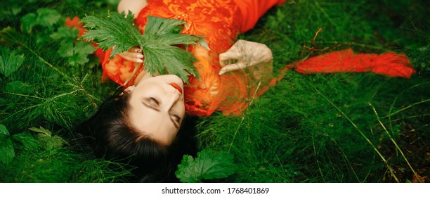 young, beautiful woman with clear, sparkling skin on her face and body is lying in a tropical forest. Natural organic skin care. The concept of harmony with nature. - Shutterstock ID 1768401869
