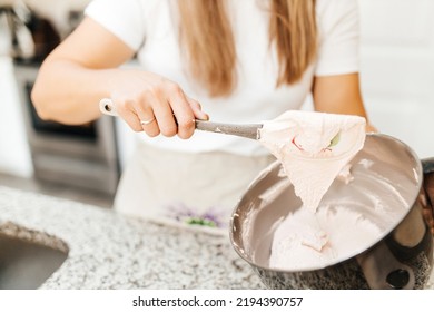 A Young Beautiful Woman Cooks In A Bright Kitchen. Cooking Macaroons. A Cute Girl Prepares Dough For Cakes, Hands And Ingredient Closeup. Cooking Macaroons. Cookie Baking