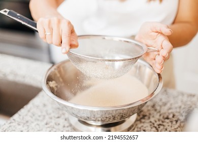 A Young Beautiful Woman Cooks In A Bright Kitchen. Cooking Macaroons. A Cute Girlp Repares Dough For Cakes, Hands And Ingrident Closeup. Cooking Macaroons. Cookie Baking