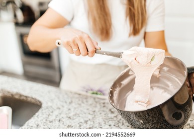 A Young Beautiful Woman Cooks In A Bright Kitchen. Cooking Macaroons. A Cute Girlp Repares Dough For Cakes, Hands And Ingrident Closeup. Cooking Macaroons. Cookie Baking