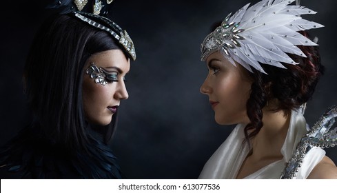 Young Beautiful Woman In Costume Black And White Angel.Beautiful Professional  Make-up , Perfect Headdress With Natural  Feathers And Rhinestones , The Same Model In Different Outfits