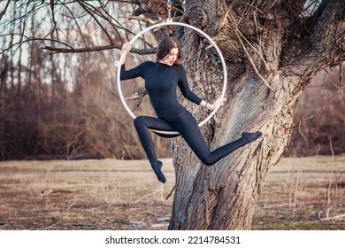 Young Beautiful Woman Dancing On An Aerial Ring Outside