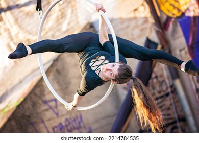 Young Beautiful Woman Dancing On An Aerial Ring Outside