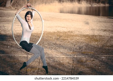 Young Beautiful Woman Dancing On An Aerial Ring Outside