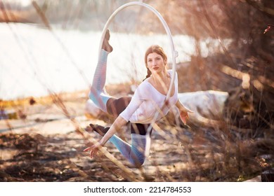 Young Beautiful Woman Dancing On An Aerial Ring Outside