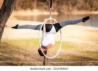 Young Beautiful Woman Dancing On An Aerial Ring Outside