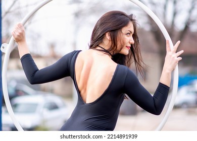 Young Beautiful Woman Dancing On An Aerial Ring Outside