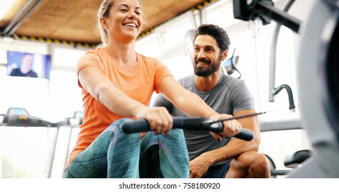 Young beautiful woman doing exercises with personal trainer - Shutterstock ID 758180920