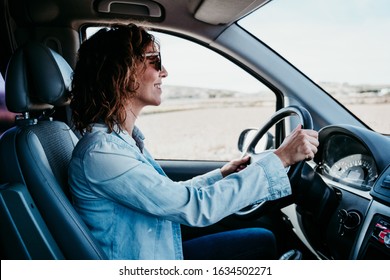 Young Beautiful Woman Driving A Van. Travel Concept