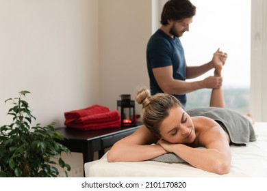 Young and beautiful woman during foot massage in professional massage clinic - Powered by Shutterstock