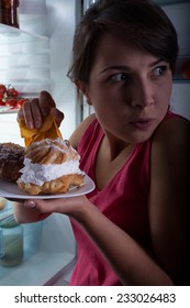 Young Beautiful Woman Eating Cakes In Secret