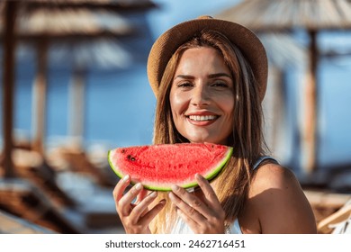 Young beautiful woman eating juicy watermelon on the beach. - Powered by Shutterstock