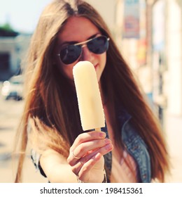 Young Beautiful Woman Eating Popsicle Ice Pop. Photo Toned Style Instagram Filters