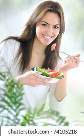 Young Beautiful Woman Eating Salad