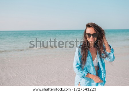 Young beautiful woman at empty beach