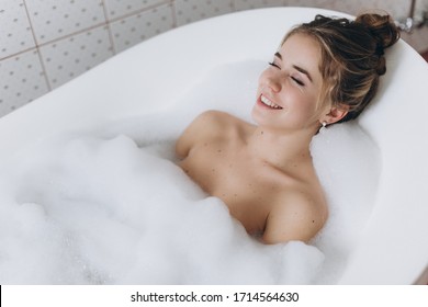 A young beautiful woman is enjoying a hot bath - Powered by Shutterstock