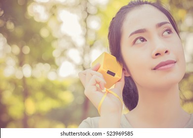 Young Beautiful Woman Enjoying The Music At  Outdoor Park.Woman Listening Music By Bluetooth Speaker At  Outdoor Park.