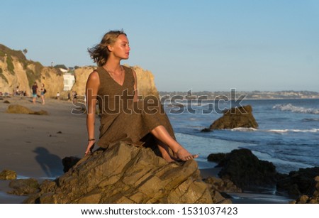 Young Beautiful Woman Enjoying Sunset at El Matador State Beach in Malibu, California